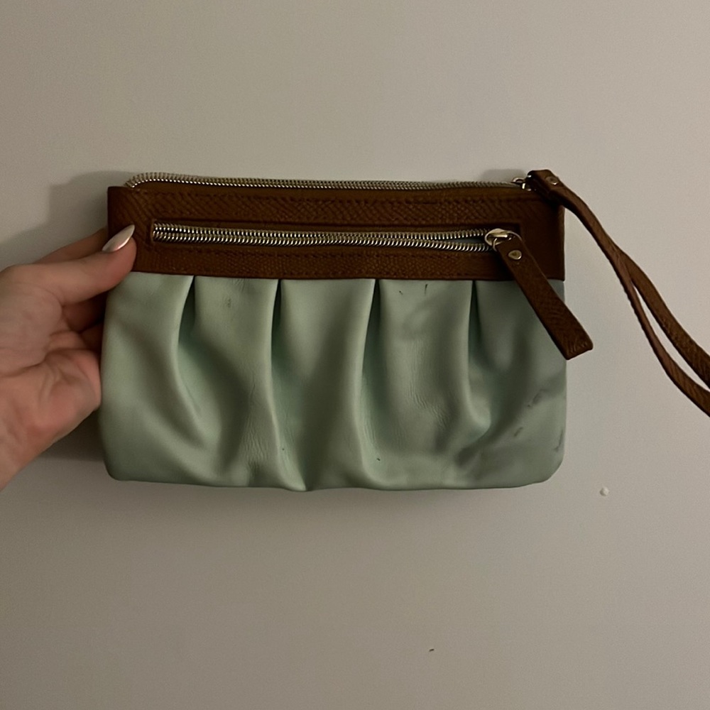 Light green wristlet with brown and gold accents, outside zip, card holder